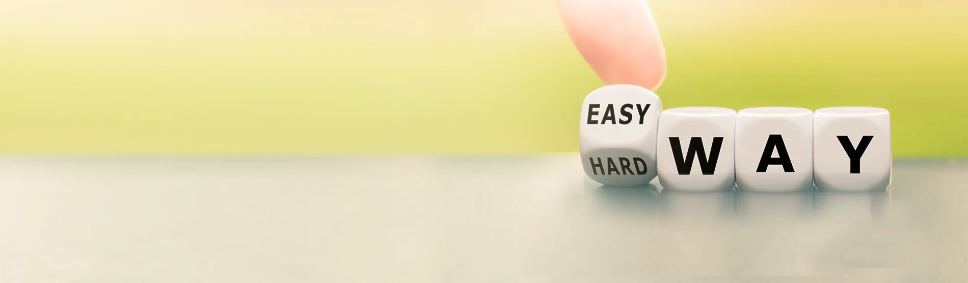 Hand turns a dice and changes the expression "hard way" to "easy way".