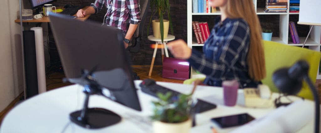 coworkers sharing momeny at desk