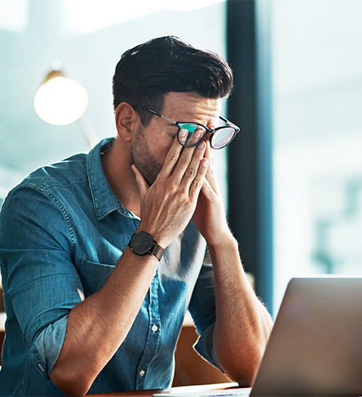 stressed and tired business man at laptop